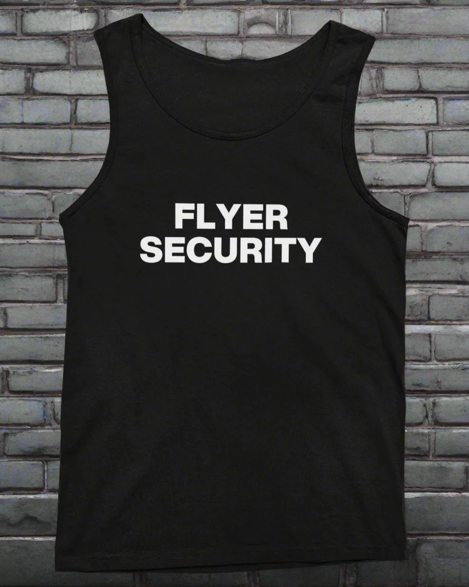 Flat lay of a vintage black unisex tank top with bold white “FLYER SECURITY” text, displayed against a dark brick wall with subtle purple neon lighting for a bold, edgy aesthetic.