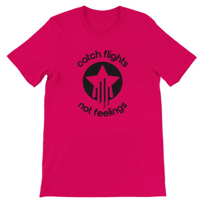 Fuchsia unisex t-shirt with a bold black graphic that reads “catch flights not feelings” curved around a star and streak icon, printed on the chest.