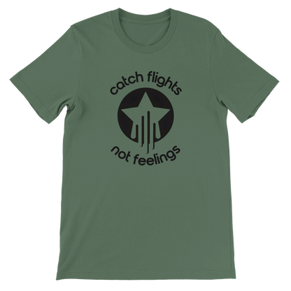 Military green unisex t-shirt with a bold black graphic that reads “catch flights not feelings” curved around a star and streak icon, printed on the chest.