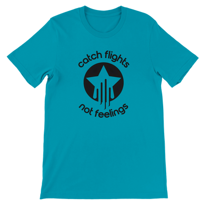 Teal unisex t-shirt with a bold black graphic that reads “catch flights not feelings” curved around a star and streak icon, printed on the chest.