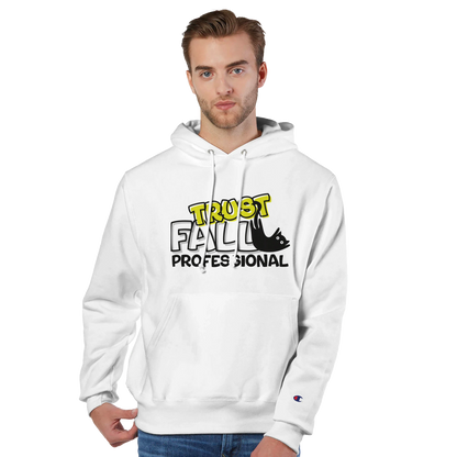 Model wearing a white Champion pullover hoodie with the “Trust Fall Professional” graphic on the front, featuring bold yellow and black lettering and a falling cat illustration.
